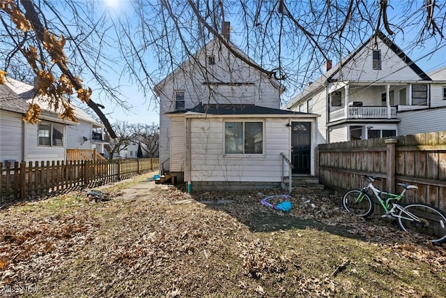 rear view of property featuring fence private yard and entry steps