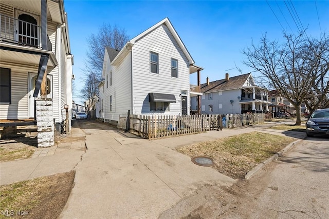 view of front of house with a fenced front yard and a residential view