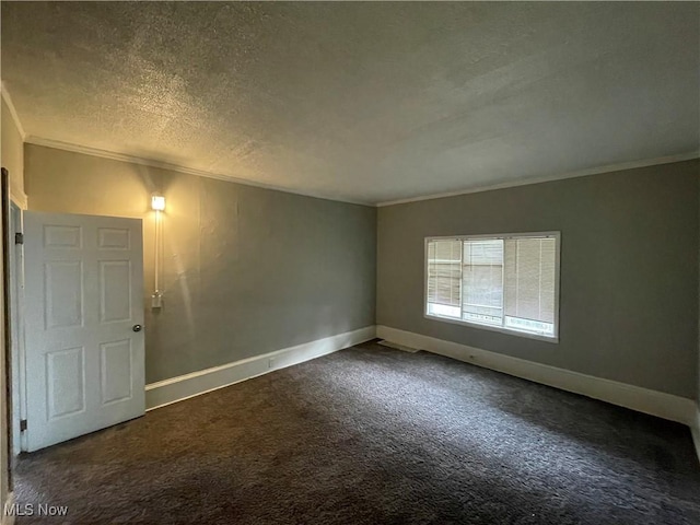 carpeted spare room with a textured ceiling, crown molding, and baseboards