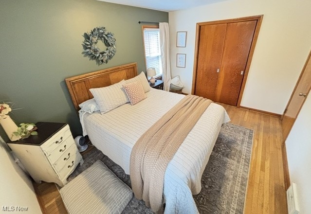 bedroom with wood finished floors and baseboards