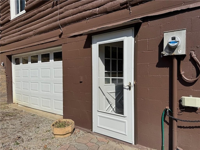 view of exterior entry with a garage