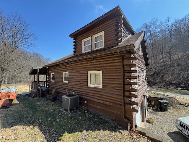 view of property exterior with log exterior and central AC