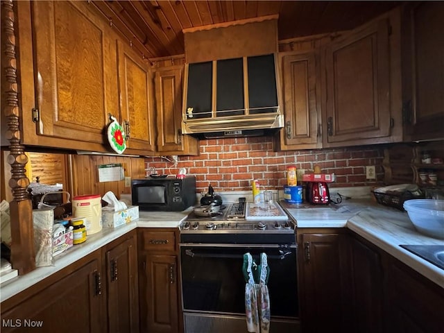 kitchen featuring brown cabinetry, light countertops, black microwave, range with electric stovetop, and wooden ceiling