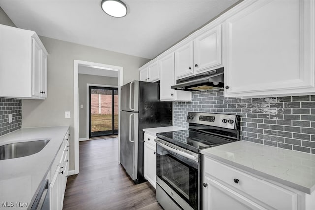 kitchen featuring under cabinet range hood, stainless steel appliances, and white cabinetry