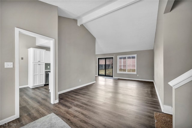 unfurnished living room featuring beam ceiling, dark wood-style floors, high vaulted ceiling, and baseboards