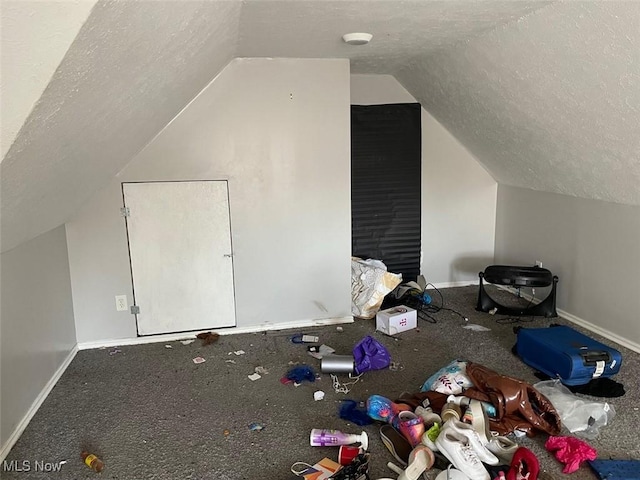 bonus room with baseboards, a textured ceiling, and lofted ceiling