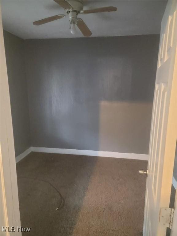 spare room with baseboards, carpet, and ceiling fan