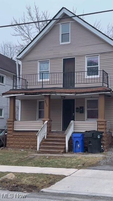 view of front of house with a balcony and covered porch