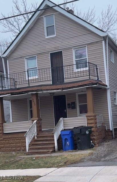 view of front of home with a porch and a balcony