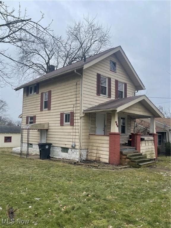 view of side of home with a yard