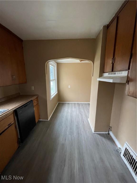 kitchen with black dishwasher, wood finished floors, visible vents, and under cabinet range hood