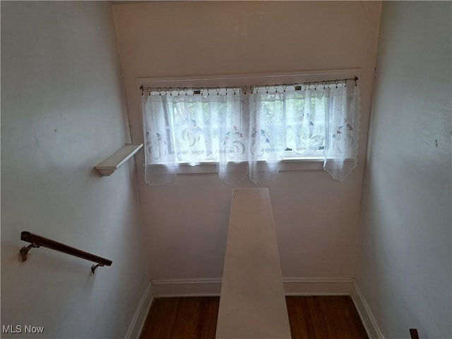 interior space featuring wood finished floors and baseboards