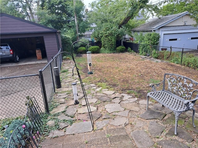 view of yard with an outbuilding, fence, and a garage