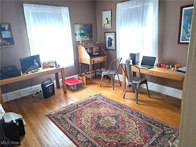 office space featuring baseboards and wood finished floors