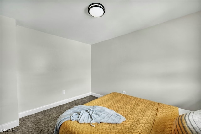 carpeted bedroom featuring baseboards