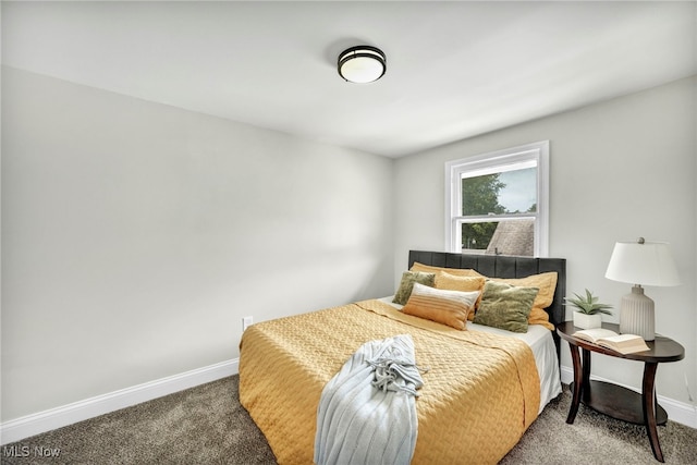 carpeted bedroom featuring baseboards