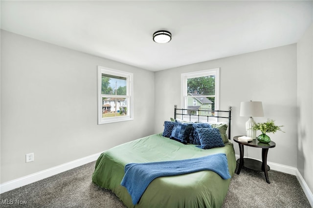 bedroom featuring baseboards and carpet floors