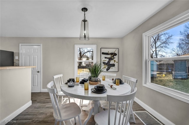 dining room with baseboards and dark wood-style flooring