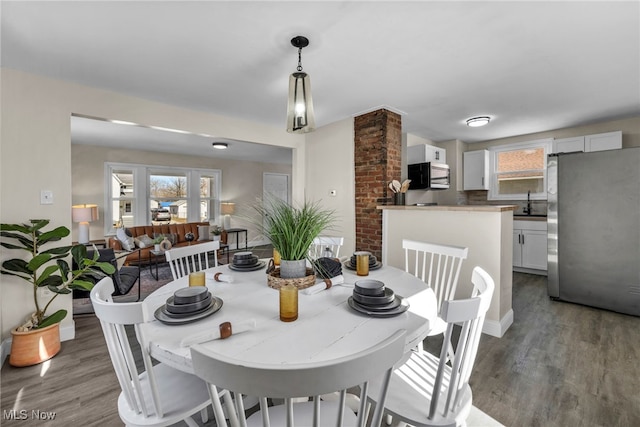 dining area featuring a healthy amount of sunlight and wood finished floors