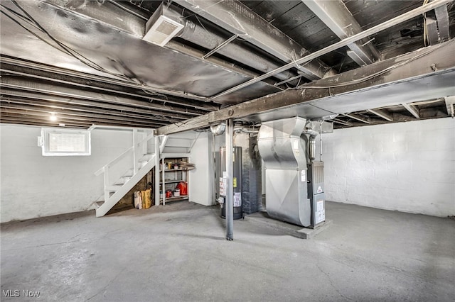 below grade area with stairway, heating unit, visible vents, and water heater