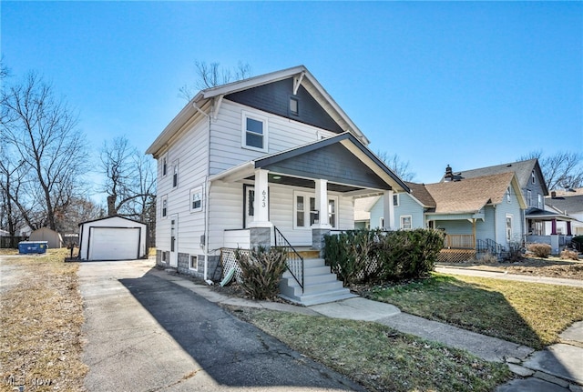 view of front of home with an outbuilding, covered porch, concrete driveway, and a detached garage