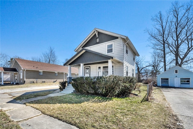 view of front of home with a garage, covered porch, an outdoor structure, and a front yard