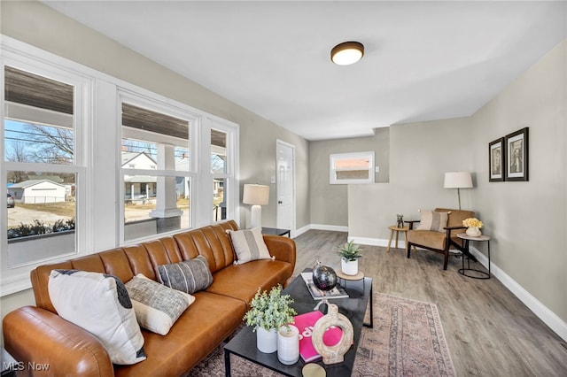 living room with plenty of natural light, baseboards, and wood finished floors