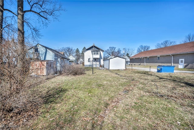 view of yard featuring fence, an outdoor structure, and a shed