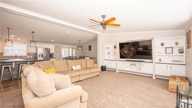 living room with a wealth of natural light, light colored carpet, a ceiling fan, and vaulted ceiling