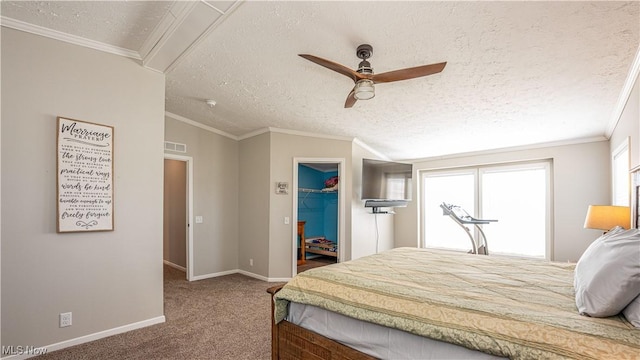 carpeted bedroom with baseboards, visible vents, a spacious closet, a textured ceiling, and crown molding