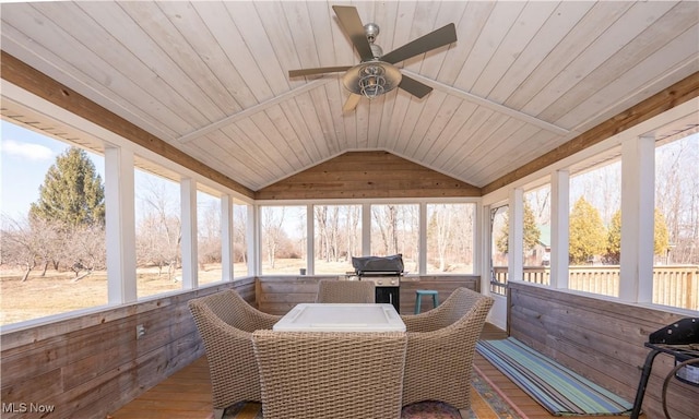 sunroom / solarium featuring lofted ceiling, wood ceiling, and a ceiling fan