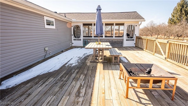 wooden deck with a sunroom