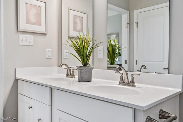 bathroom featuring double vanity and a sink