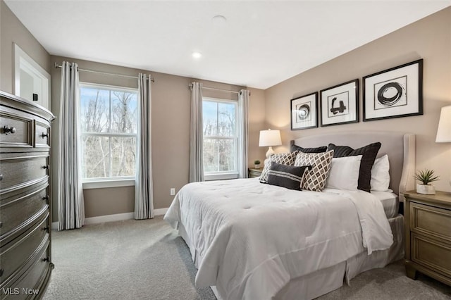 carpeted bedroom with multiple windows and baseboards