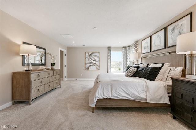 bedroom featuring light carpet and baseboards