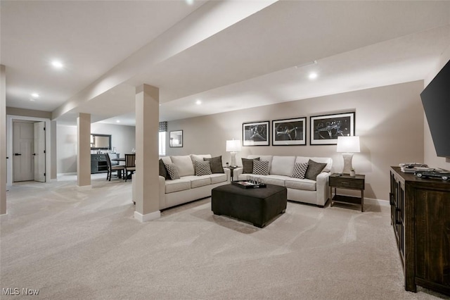 living room with recessed lighting, baseboards, and light carpet