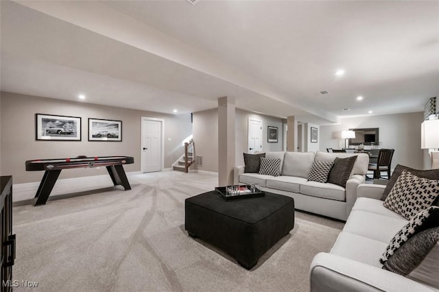 living room with recessed lighting, baseboards, light carpet, and stairs