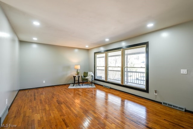 unfurnished room with recessed lighting, visible vents, and wood-type flooring