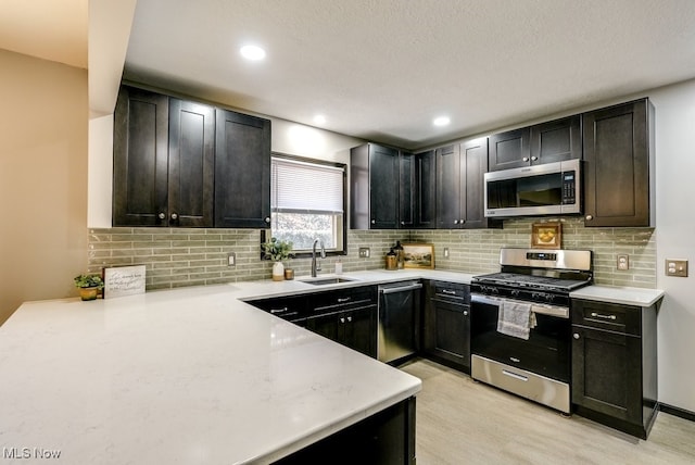 kitchen featuring light countertops, appliances with stainless steel finishes, and a sink