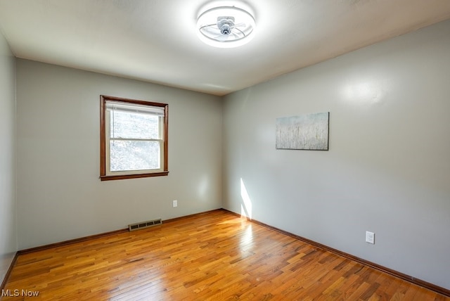 unfurnished room with light wood-type flooring and visible vents