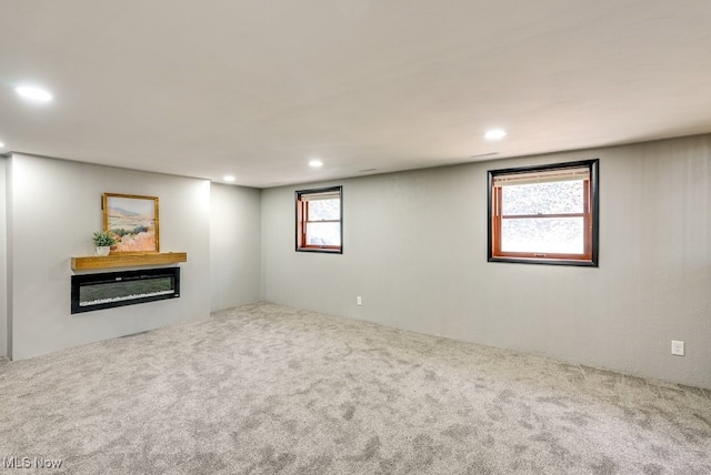 basement featuring recessed lighting and carpet