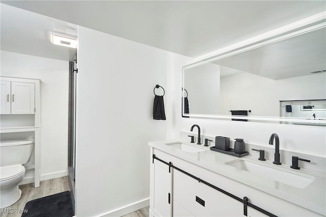 full bathroom featuring a sink, visible vents, toilet, and wood finished floors