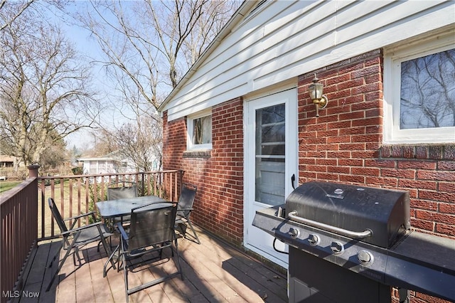 deck with area for grilling and outdoor dining area