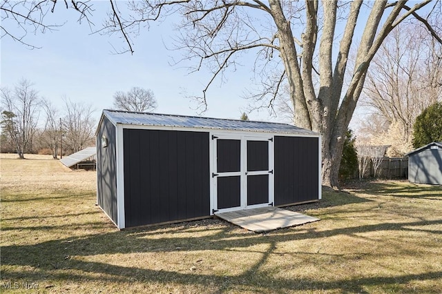 view of shed featuring fence