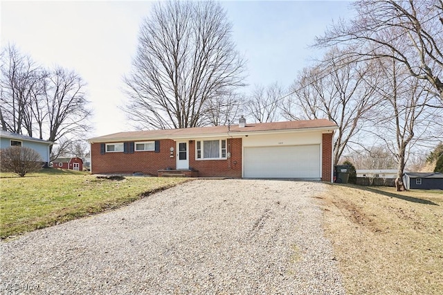 ranch-style house with brick siding, gravel driveway, a front yard, a chimney, and a garage