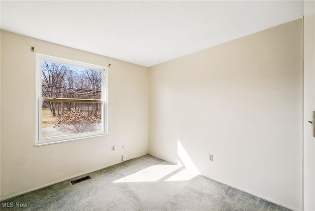 carpeted spare room with visible vents