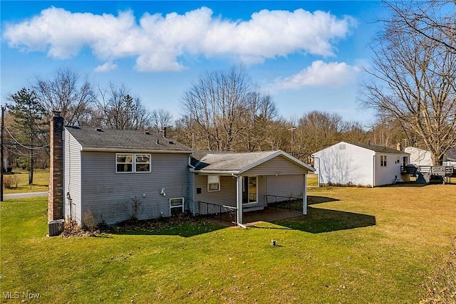 rear view of property featuring a chimney and a yard