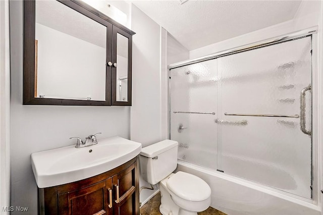 bathroom with enclosed tub / shower combo, toilet, vanity, and a textured ceiling