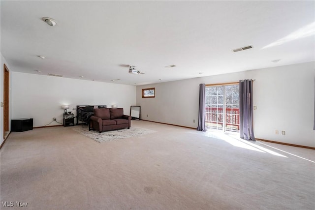 living room with visible vents, light colored carpet, and baseboards