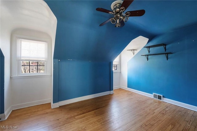 bonus room with visible vents, baseboards, wood finished floors, and a ceiling fan